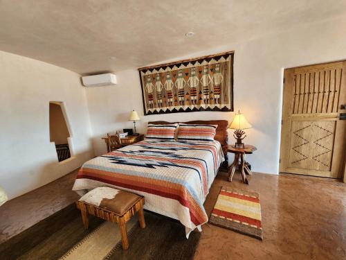 a bedroom with a large bed with a wooden headboard at Sky Village in Cortez