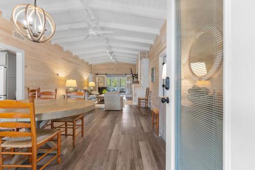 a dining room and living room with a table and chairs at Private Pool and Just a 3 Minute Walk to the Beach in Pawleys Island