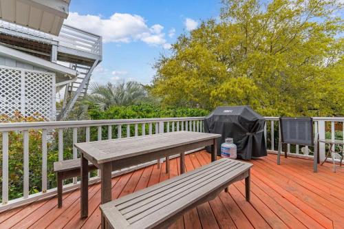 a wooden deck with a picnic table and a tent at Private Pool and Just a 3 Minute Walk to the Beach in Pawleys Island