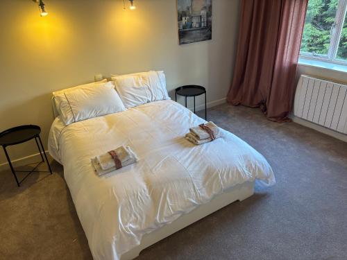 a bedroom with a white bed with two towels on it at Stylish Dublin4 - One Bedroom Apt in Dublin
