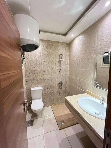 a bathroom with a toilet and a sink at COMFY ZONe in Sharm El Sheikh
