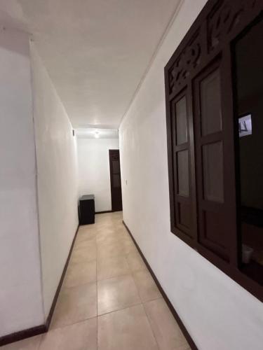 an empty hallway with a door and a tile floor at Hotel Santa Marta Centro Histórico in Popayan