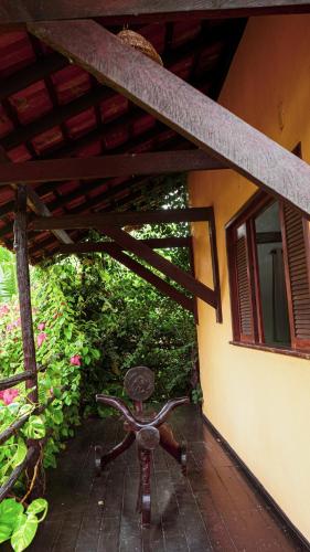 a bench sitting on the porch of a house at Vila Ypáwa 150 m centro 30 m praia lago verde in Alter do Chao