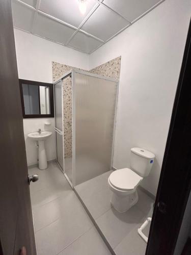 a bathroom with a toilet and a sink at Hotel Santa Marta Centro Histórico in Popayan