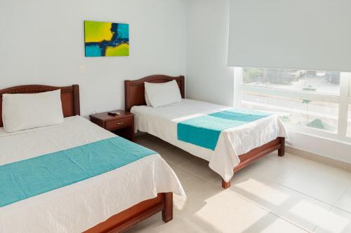 Ein Bett oder Betten in einem Zimmer der Unterkunft Sanha Plus Hotel