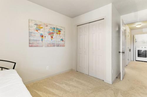 a bedroom with a bed and a painting on the wall at Executive Townhouse To Stay in Colorado Springs