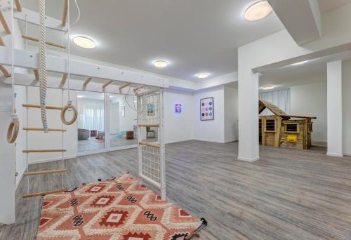 a large room with a staircase and a living room at Apartment "Haffbrise" in Zirchow
