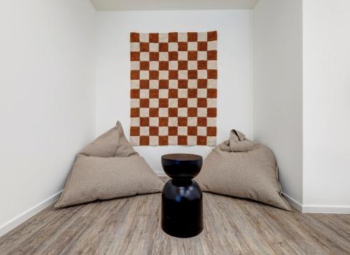 a vase sitting on the floor next to pillows at Apartment "Haffbrise" in Zirchow