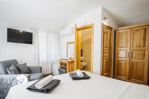 a hotel room with a bed and a couch at Hotel Šiška in Ljubljana