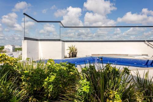 a swimming pool on the side of a building at Central Playa del Carmen Master Suite with rooftop pool and gym WiFi free parking near beach in Playa del Carmen