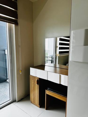 a bathroom with a sink and a mirror at Wind Suites Tagaytay Condotel in Tagaytay