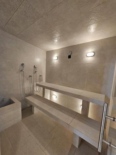 a bathroom with a bench and a shower at Exclusive Apartasuite El Encanto in Santa Marta
