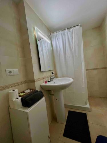 a white bathroom with a sink and a shower at Apartment with the pool in Moncófar