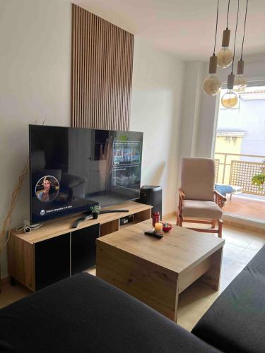 a living room with a large flat screen tv at Apartment with the pool in Moncófar