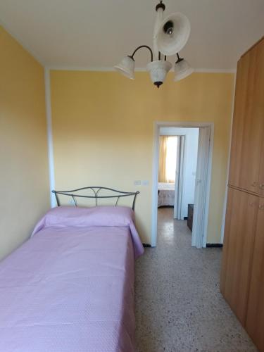 a bedroom with a bed and a ceiling fan at Ca`d' Alessio in Merizzo