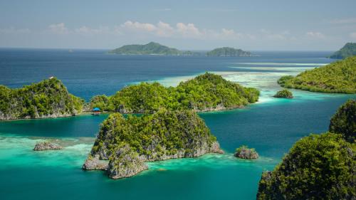 an aerial view of a group of islands in the ocean at Wai Resort - Raja Ampat in Pulau Birie