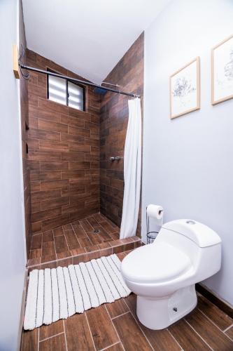 a bathroom with a toilet and a shower at Life Hospitality in Ensenada