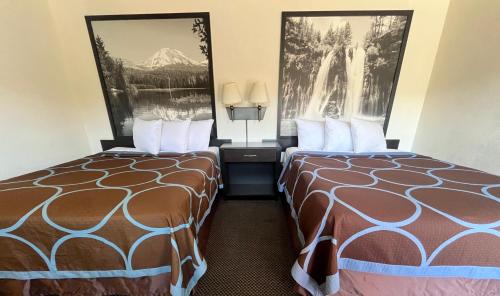 a hotel room with two beds next to each other at Super 8 by Wyndham Red Bluff in Red Bluff