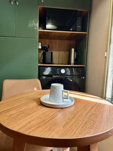 a table with a cup on top of it at Central Cozy Minimalist Studio apartment in Maroko