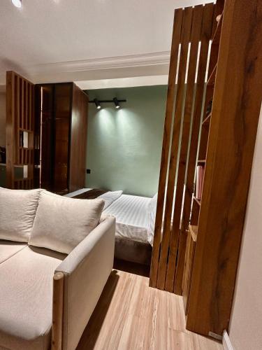 a bedroom with a bed and a couch in it at Central Cozy Minimalist Studio apartment in Maroko