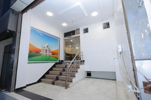 a staircase in a building with a painting on the wall at R k guest house in Agra