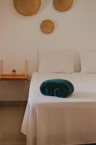 a blue towel is sitting on a bed at Casa cacau - Casinhas da Serena in Caraíva