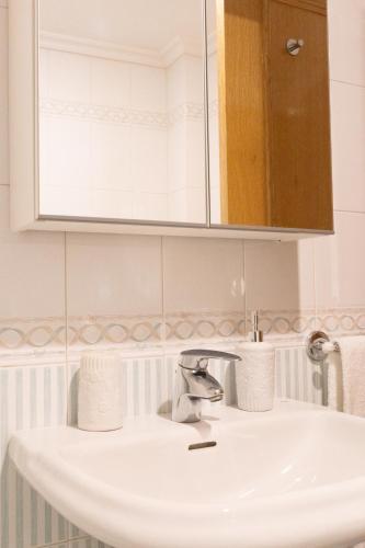 a bathroom with a sink and a mirror at Estúdio AMar - Always Algarve in Porches