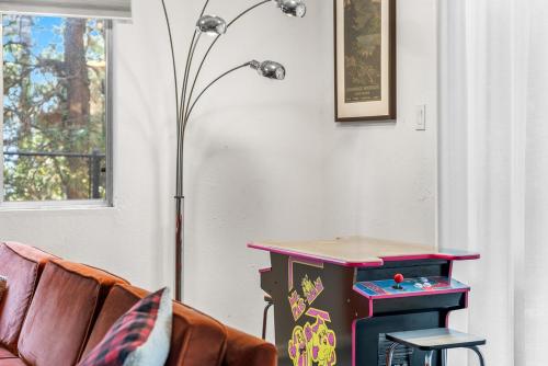 a living room with a table and a lamp at Luxury A-Frame Retreat in Lake Arrowhead
