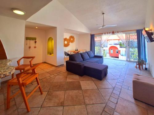 a living room with a blue couch and a table at Casa di Cesare in Playa del Carmen