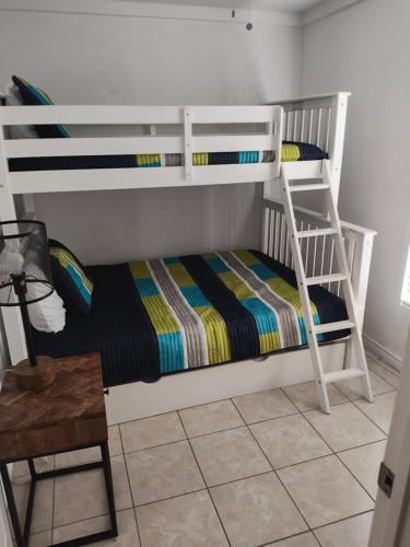 a bedroom with two bunk beds and a table at Short Walk to Beach 1 in South Padre Island