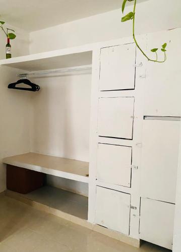 a closet with white drawers and a shelf at Casa Semilla in Holbox Island