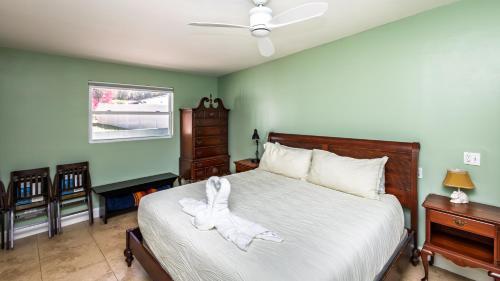 a bedroom with a bed with a white robe on it at Lakefront Retreat - Boat - Fish - Close to all Orlando Parks - Disney - Universal - SeaWorld in Orlando