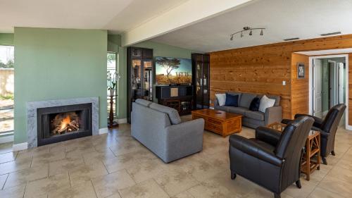 a living room with couches and a fireplace at Lakefront Retreat - Boat - Fish - Close to all Orlando Parks - Disney - Universal - SeaWorld in Orlando