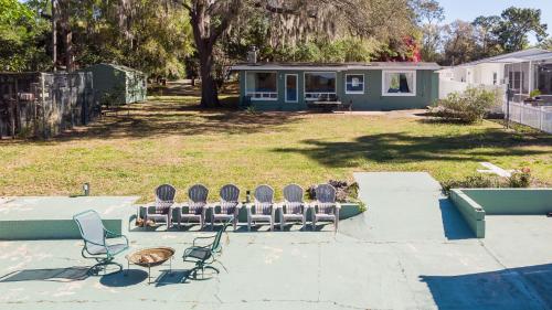 a group of chairs sitting in a yard at Lakefront Retreat - Boat - Fish - Close to all Orlando Parks - Disney - Universal - SeaWorld in Orlando