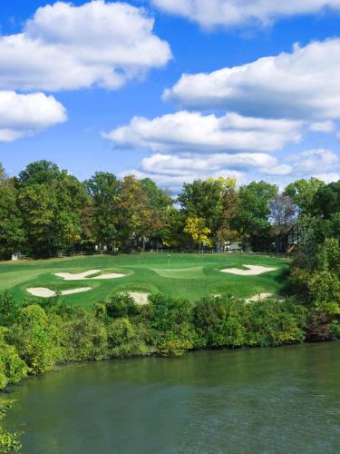 a view of a golf course next to a river at Lodge of Four Seasons Golf Resort, Marina & Spa in Lake Ozark