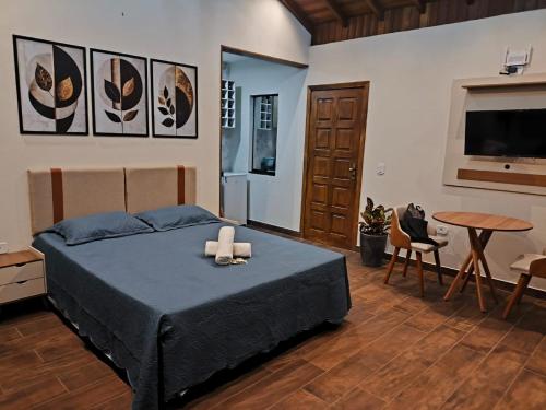a bedroom with a bed with two candles on it at Chalé Vista da Serra in Cunha
