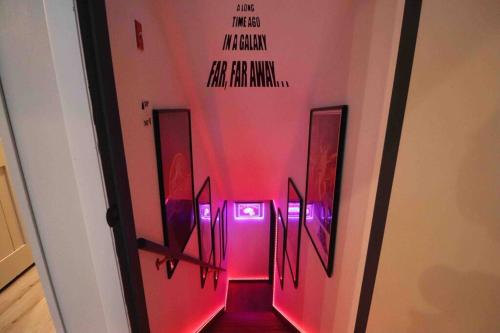a hallway with pink lights in a room at Villa MiaNova A Modern Hideout in the Woods in Lake Ariel