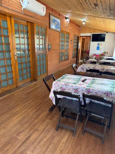 a room with two tables and chairs in a building at Pousada Agua Quente in Olímpia