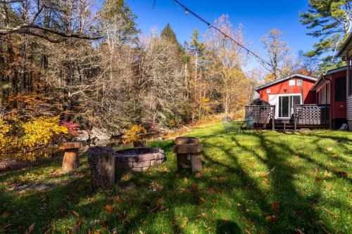 a house in the middle of a yard with trees at Heated Indoor Private Pool Stream Front Game Room in Cresco