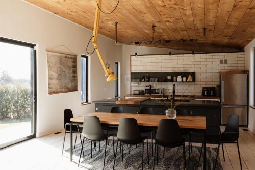 a kitchen and dining room with a table and chairs at Willow Creek - Modern Sunlit Bungalow in Hillier