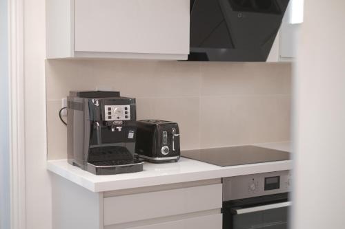 a kitchen with a coffee maker on a counter at Eblana House in Dublin