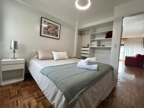 a bedroom with a large bed and a mirror at Sarmiento Home in Buenos Aires