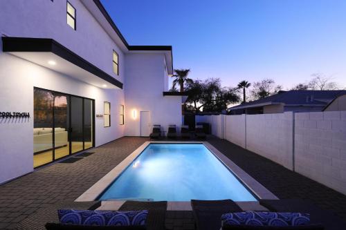 a swimming pool in the backyard of a house at LUXE - Nouveau - Sparkling Pool - Walk to Old Town in Scottsdale