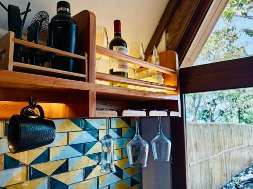a kitchen with bottles of wine on the wall at Luxe A-Frame on Lake Atitlán in Santiago Atitlán