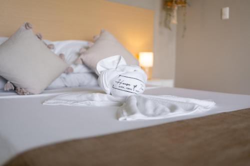 a stuffed animal sitting on top of a bed at House of Turri Suite Views Terrace & Jacuzzi in Verbena Norte