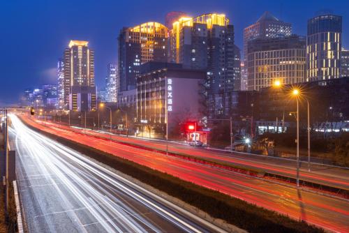 a city skyline at night with traffic on a highway at Atour X Hotel Beijing CBD International Trade Bridge in Beijing
