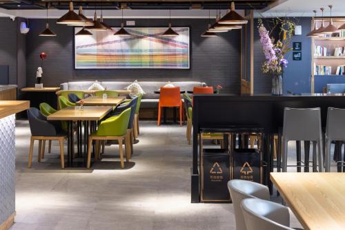 a restaurant with tables and chairs and a bar at Atour X Hotel Beijing CBD International Trade Bridge in Beijing