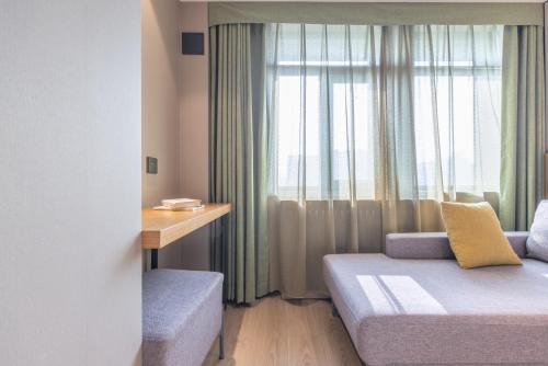 a small room with a bed and a window at Atour X Hotel Beijing CBD International Trade Bridge in Beijing