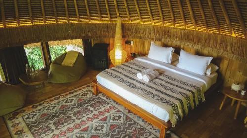 a bedroom with a bed in a room at Alpaca Lodge in Tanah Lot