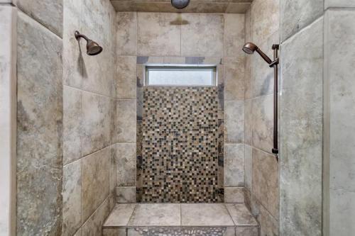 a bathroom with a shower with a glass door at Entertainment Castle - Large Group & Company Func in Meridian